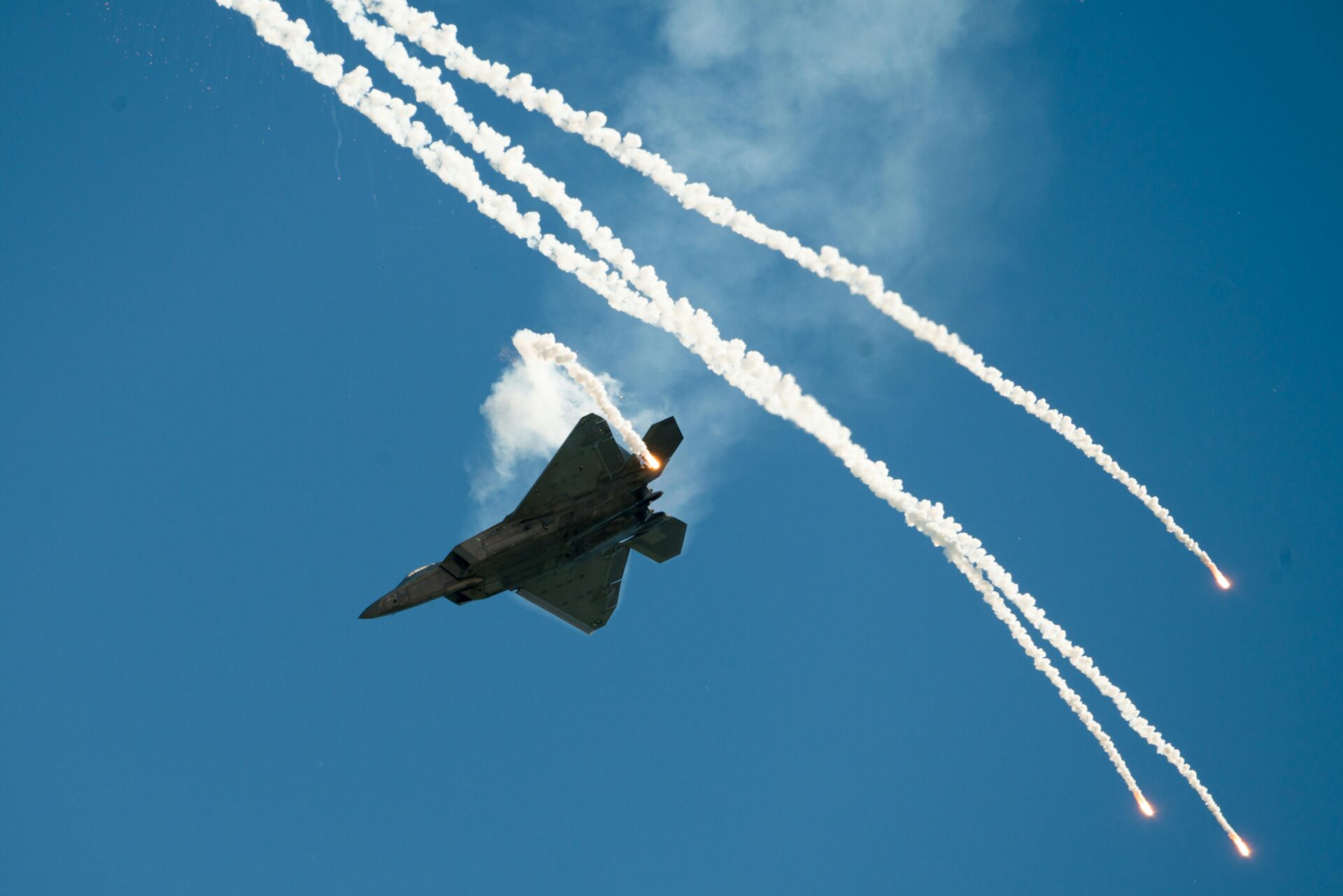 Fighter jet evading missiles