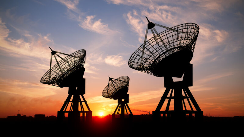 Three satelite dishes at sunset
